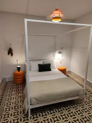 a bedroom with a white bed with a canopy at castellano home in Jerez de la Frontera