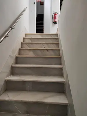 a staircase leading up to a hallway with a fire hydrant at castellano home in Jerez de la Frontera