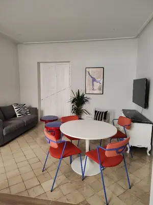 a living room with a table and chairs at castellano home in Jerez de la Frontera