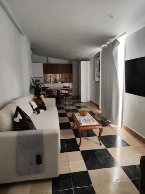 a living room with a couch and a table at castellano home in Jerez de la Frontera