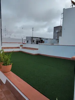 a balcony with a green lawn on a building at castellano home in Jerez de la Frontera
