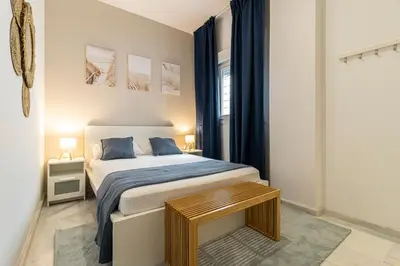 a small bedroom with a bed and a window at Jerez Boutique by Sanz in Jerez de la Frontera