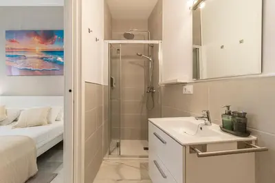 a small bathroom with a shower and a sink at Jerez Boutique by Sanz in Jerez de la Frontera