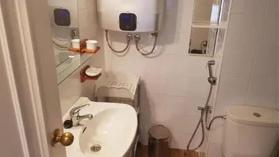 a small bathroom with a sink and a toilet at Apartamento en primera línea de playa en 2ª planta in Novo Sancti Petri