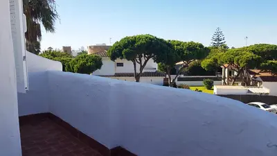a white wall with a view of a house at Apartamento en primera línea de playa en 2ª planta in Novo Sancti Petri