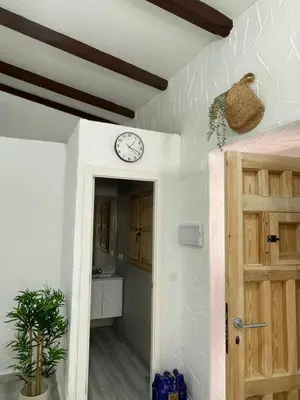 a room with a clock on the wall and a door at Apartamento La Catavina in Jerez de la Frontera