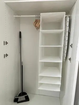 a walk in closet with white shelves and a broom at Apartamento La Catavina in Jerez de la Frontera