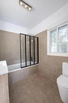 a bathroom with a tub and a toilet and a window at Finca Feliciano in Novo Sancti Petri