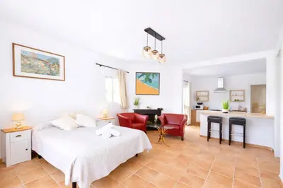 a white bedroom with a bed and a desk at Finca Feliciano in Novo Sancti Petri