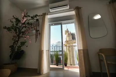 a room with a window with a view of a building at La Zarzamora in Jerez de la Frontera