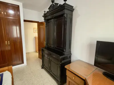a large black cabinet in a room with a tv at RESIDENCIAL EL CANO in Rota
