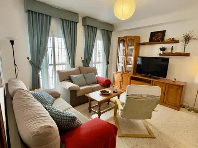 a living room with a couch and a tv at RESIDENCIAL EL CANO in Rota