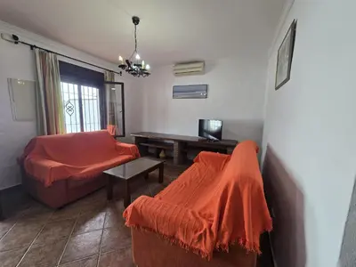 a living room with a couch and a table at Casas el Palomar in Conil de la Frontera