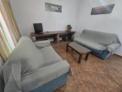 a living room with a couch and a table at Casas el Palomar in Conil de la Frontera