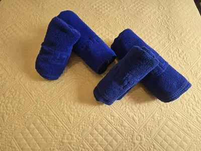 three blue knitted gloves sitting on top of a bed at Casas el Palomar in Conil de la Frontera