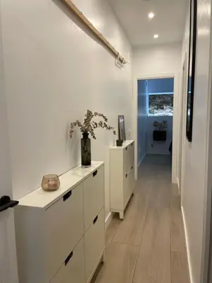 a kitchen with white cabinets and a hallway at Casa Cristina in Cádiz