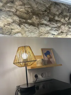 a lamp on a table with a picture and a shelf at Casa Cristina in Cádiz
