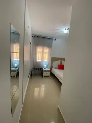 a small bedroom with a bed and a window at Banda Playa Home, Pleno Centro in Sanlúcar de Barrameda