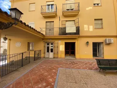 a building with a bench in front of it at Banda Playa Home, Pleno Centro in Sanlúcar de Barrameda