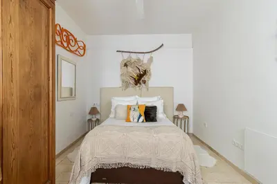 a white bedroom with a bed with pillows at NUEVO-NEW Casa Palacio M anuela in Jerez de la Frontera