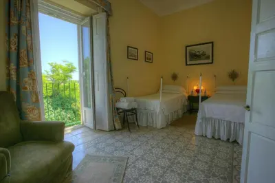 a bedroom with two beds and a large window at Hacienda La Parrilla Alta in Arcos de la Frontera