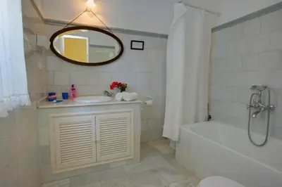 a bathroom with a sink and a tub and a mirror at Hacienda La Parrilla Alta in Arcos de la Frontera