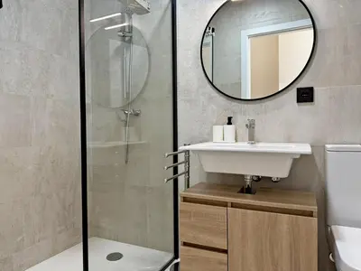 a bathroom with a shower and a sink and a mirror at La Solera de Jerez - Ole Solutions in Jerez de la Frontera