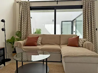 a living room with a couch and a glass table at La Solera de Jerez - Ole Solutions in Jerez de la Frontera