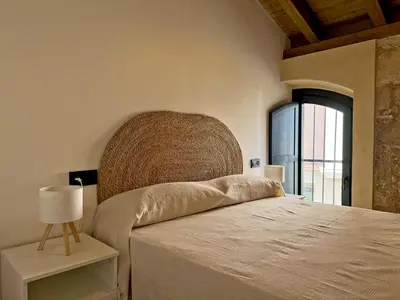 a bedroom with a large bed and a window at La Solera de Jerez - Ole Solutions in Jerez de la Frontera