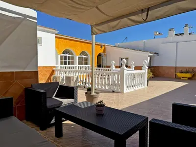 a patio with a table and chairs and a house at Casa Luz de Azahar - Ole Solutions in Jerez de la Frontera
