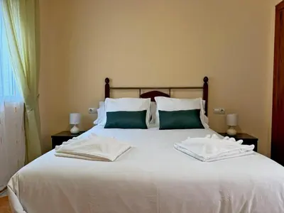 a large white bed with two pillows on it at Casa Luz de Azahar - Ole Solutions in Jerez de la Frontera
