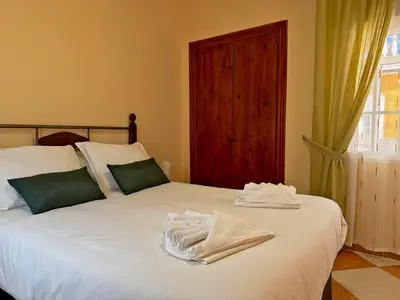 a bedroom with a bed with towels on it at Casa Luz de Azahar - Ole Solutions in Jerez de la Frontera