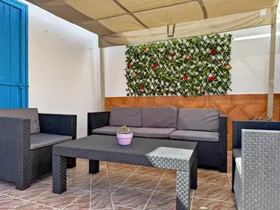 a living room with a couch and a christmas tree at Casa Luz de Azahar - Ole Solutions in Jerez de la Frontera