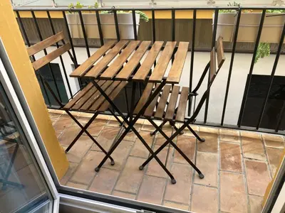 a wooden table and two chairs on a balcony at Bombonera in Jerez de la Frontera