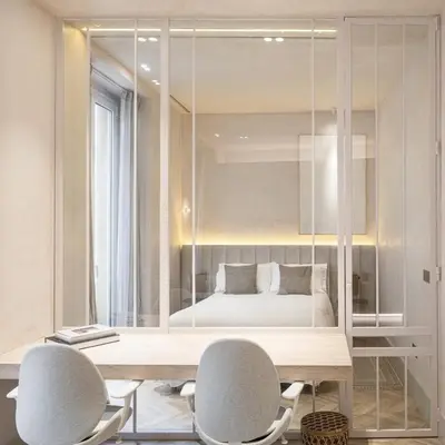 a room with a desk and two chairs and a bed at Bombonera in Jerez de la Frontera