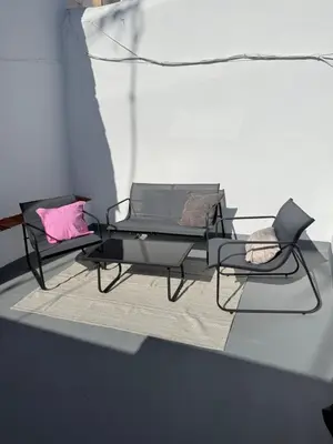 a table with two chairs and a pink pillow at Apartamento TATA, Arcos de la Frontera in Arcos de la Frontera