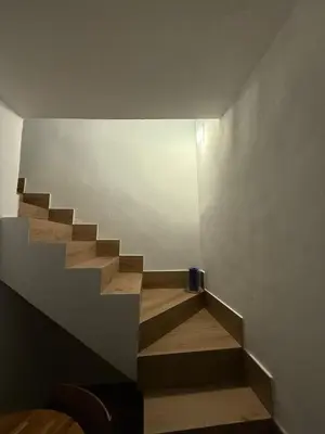 a staircase in a room with wooden floors and a wall at Apartamento TATA, Arcos de la Frontera in Arcos de la Frontera