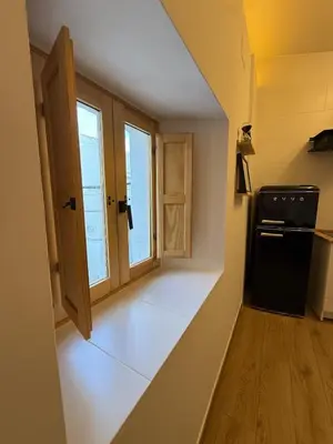 an empty kitchen with a window and a refrigerator at Apartamento TATA, Arcos de la Frontera in Arcos de la Frontera