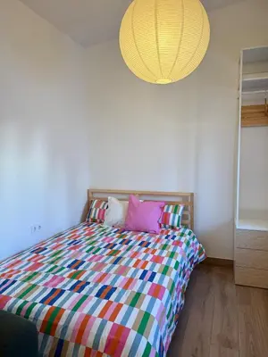 a bedroom with a bed with a colorful comforter at Apartamento TATA, Arcos de la Frontera in Arcos de la Frontera