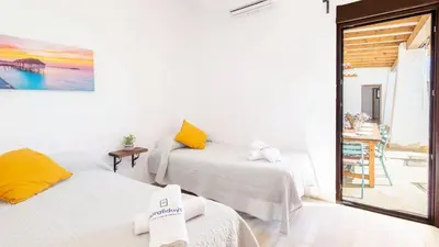 two beds in a room with a view of the ocean at Galdana Chiclana de la Frontera by Ruralidays in Chiclana de la Frontera