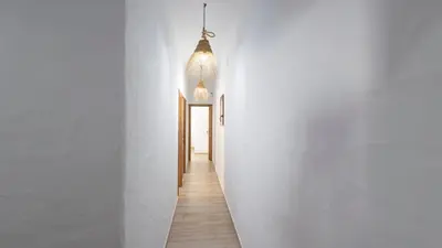 a hallway of a house with white walls and wooden floors at Galdana Chiclana de la Frontera by Ruralidays in Chiclana de la Frontera