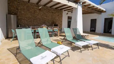 a group of chairs and a table and a pool at Galdana Chiclana de la Frontera by Ruralidays in Chiclana de la Frontera