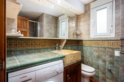 a bathroom with a toilet and a sink at Bahia Beachfront Apartment in El Puerto de Santa María