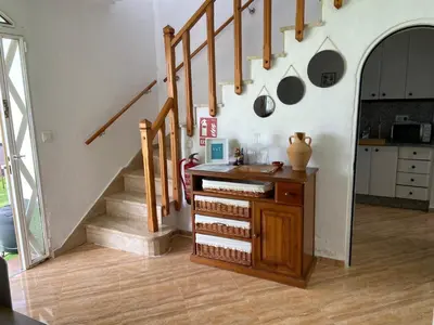 a room with a staircase with a wooden table and a counter at Dúplex a 700 m de la Playa de La Barrosa in Novo Sancti Petri