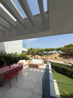 a patio with red tables and a view of the desert at Apartamento RG Acciona Vistahermosa in El Puerto de Santa María