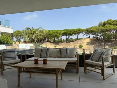 a patio with a couch and chairs and a table at Apartamento RG Acciona Vistahermosa in El Puerto de Santa María
