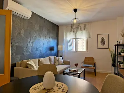 a living room with a couch and a table at Apartamento Renfurbis - Ole Solutions in Jerez de la Frontera