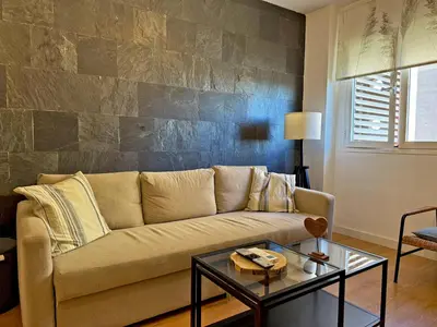 a living room with a couch and a table at Apartamento Renfurbis - Ole Solutions in Jerez de la Frontera