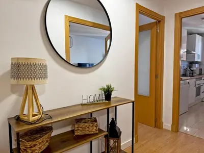 a mirror on the wall in a living room at Apartamento Renfurbis - Ole Solutions in Jerez de la Frontera