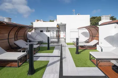 a rendering of a rooftop patio with chairs and grass at AT La Maquinilla in Jerez de la Frontera